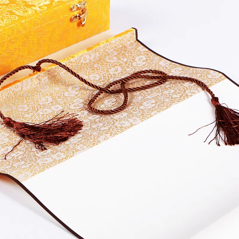 A blank scroll used for writing calligraphy works, with a scroll packaging box placed next to it.